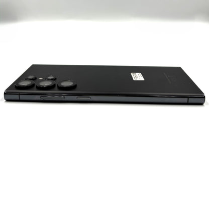 A black Samsung Galaxy S23 Ultra shown from the back, positioned horizontally against a clean white background.