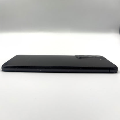 A black Samsung S21 Fe shown from the side on a plain white studio background.