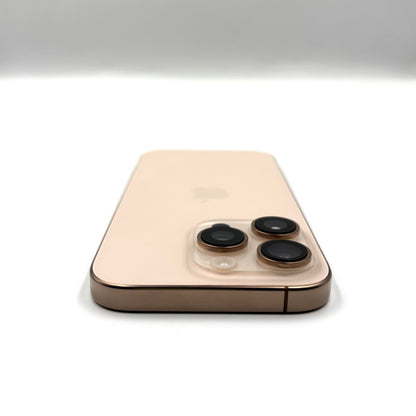 A Desert Titamium -colored iPhone 16 Pro shown from the back, featuring a clear protective camera lens protector over the three rear camera lenses, set against a clean white background.