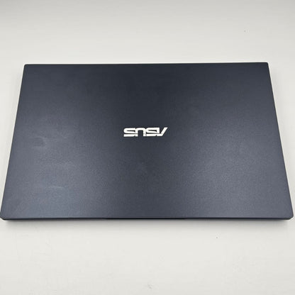 A closed dark gray ASUS laptop on a light gray background, showing the silver ASUS logo on the lid.